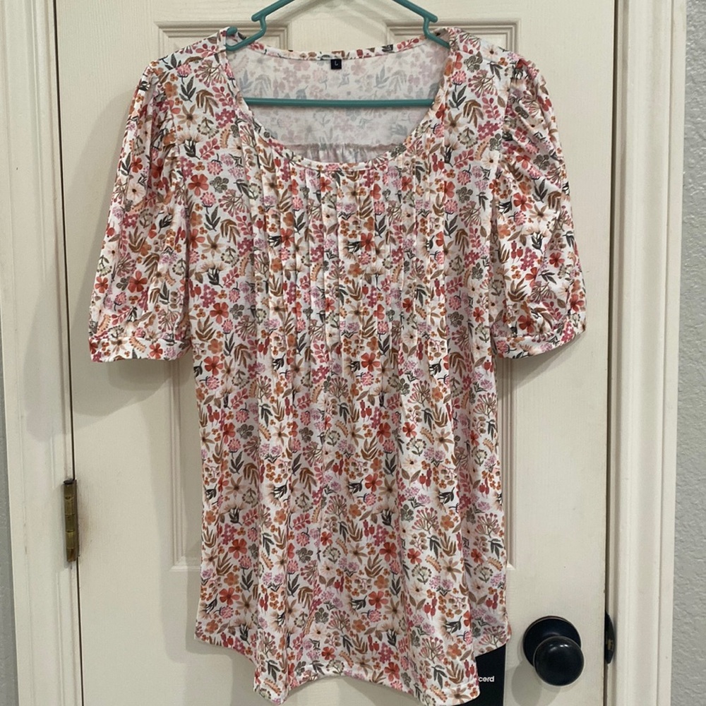 Large blouse with floral pattern.